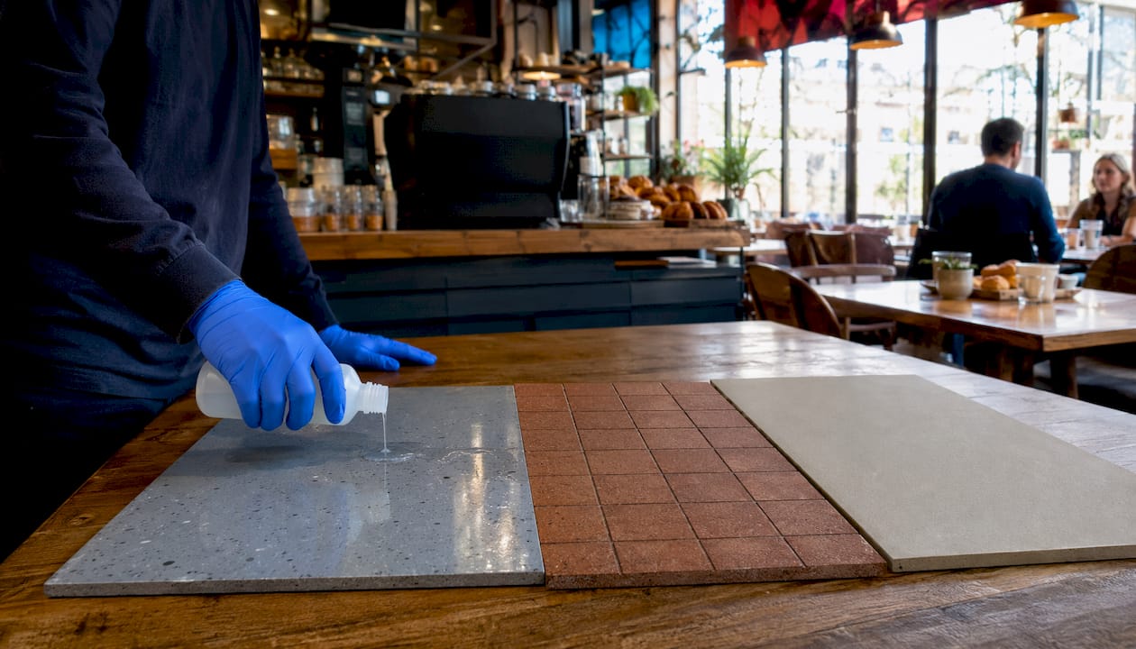 Varied commercial kitchen floor samples and cleaning tools